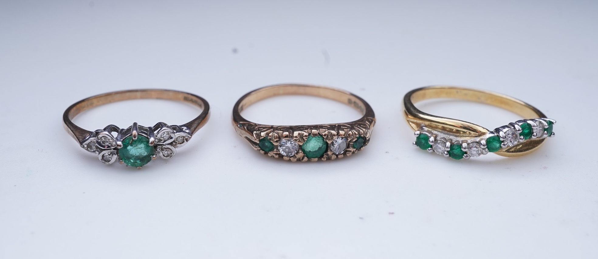 Three emerald and diamond rings